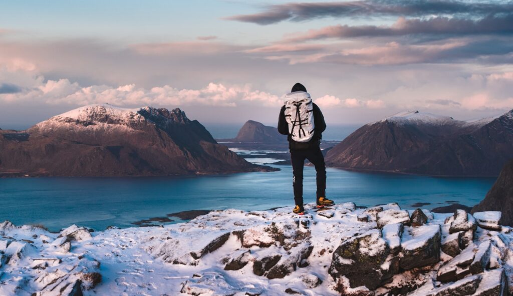 Festvagtinden Wanderung - Das Bild zeigt den atemberaubenden Ausblick vom Gipfel auf die Fjorde und Berge der Lofoten